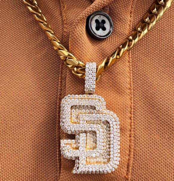 Iced-out San Diego Padres SD pendant on a gold Cuban link chain