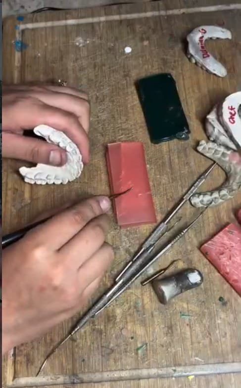 Carving tools, wax and stone molds on the bench